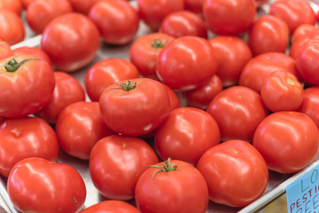 Ripe organic beefsteak tomatoes on metal tray at local market in Texas, America