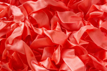 Red ribbons background. Abstract background or texture. Selective focus.