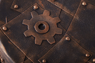 Rusty metal sheet wall with three borders of metal spikes, with orange and brown scratches and scuffs. Suitable for Wallpaper or background or grunge texture.Steampunk texture, background with mechani