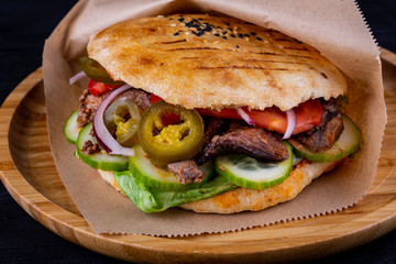 Beef pieces fried on trochanter with parsley and dill with pickles in a tortilla cooked in tandem