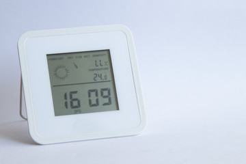 electronic clock thermometer hygrometer on a white background. copyspace for text