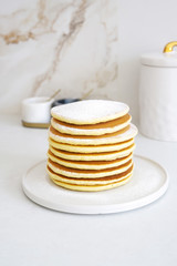 Homemade pancakes on white plate 