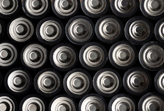 Batteries, top view, rows of alkaline battery AA size format. Energy abstract background