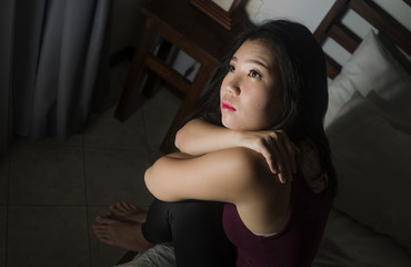 young scared and depressed Asian Korean woman suffering anxiety disorder and depression problem crying on bed in panic about covid-19 quarantine home lockdown