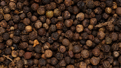 Black peppercorn background. Macro background