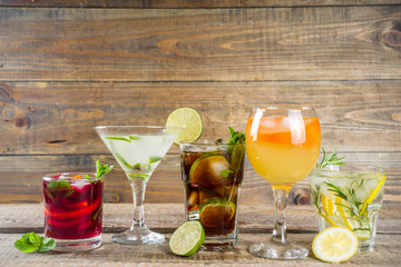 

Selection of summer alcohol drinks - mocktails and cocktails. Aperol spritz, Cube libre, Gimlet...