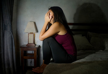 young scared and depressed Asian Korean woman suffering anxiety disorder and depression problem crying on bed in panic about covid-19 quarantine home lockdown