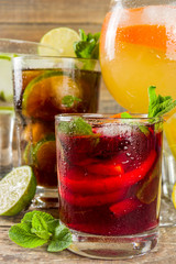 

Selection of summer alcohol drinks - mocktails and cocktails. Aperol spritz, Cube libre, Gimlet martini, mojito, sangria. Various cold summer bar and party beverages on wooden background copy space

