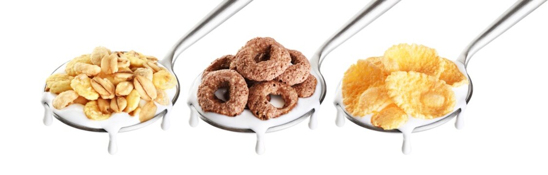 Spoon with corn rings, oat granola, cornflakes and yogurt isolated on white background.