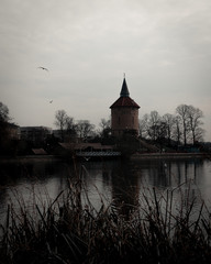 Obraz premium An old water tower is placed on a small hill in a public park called Pildammsparken in Malmö, Sweden. Here seen on a dark spring day.