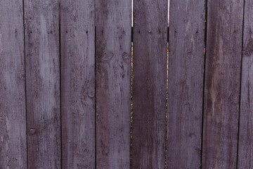 Closeup dark violet rough wood fence. Beautiful lilac not flat background. 