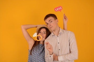 love young couple on a yellow background happiness