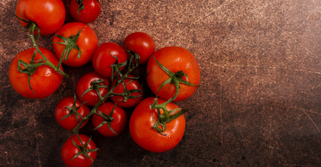 Composition with fresh tomatoes on dark background