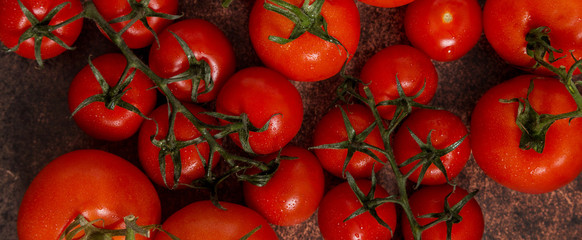 Various red tomatoes as big red and cherry tomatoes as background for text