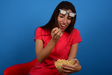 woman in 3d glasses laughing with popcorn