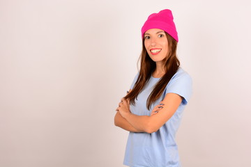 Pretty woman smiling in a pink hat looking at the camera