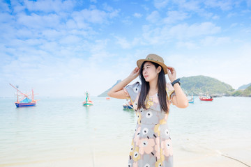 Fototapeta na wymiar Portrait young asian woman walk smile and happy on the beach sea and ocean for leisure travel in holiday vacation