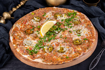 Lahmajut with nuts baked in oven and served with greens and lemon