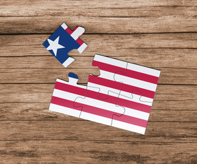 Liberia national flag on jigsaw puzzle. One piece is missing. Danger concept.
