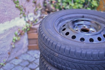 car tires in a small backyard during tire change