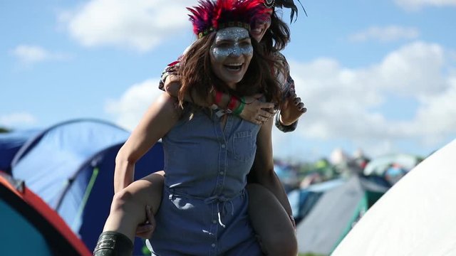 Friends camping and having fun at summer festival