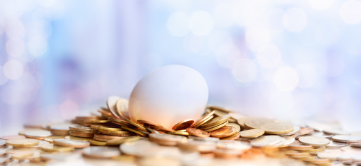 Hatched egg and coins stack. Pension fund, 401K, Strategies and plan for passive income. Saving money and investment. Risk management for business growth. Manage money in retirement.