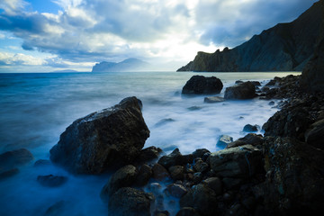 Ocean, clouds and rocky mountains