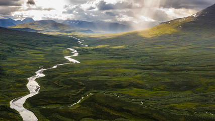 Sun rays on mountain valley, Sweden.
