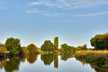 Image of La Vilaine River, Brittany, France with trees and reflections.