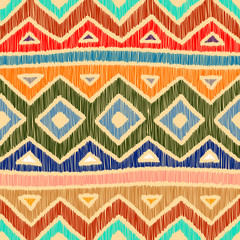 Embroidered ethnic seamless pattern. Aztec and tribal motifs. Striped mexican ornament hand drawn. Green, blue, red, orange and blue colors. Print in the bohemian style. Vector illustration.