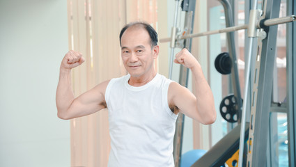 Fototapeta na wymiar elderty man asian exercising in the gym