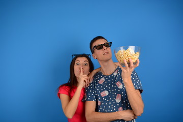 young couple with popcorn in cinema