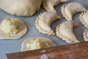 Uncooked vareniki (dumplings) with mashed potato, traditional Ukrainian food