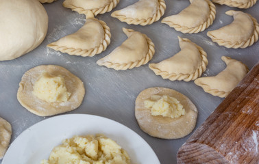 Uncooked vareniki (dumplings) with mashed potato, traditional Ukrainian food