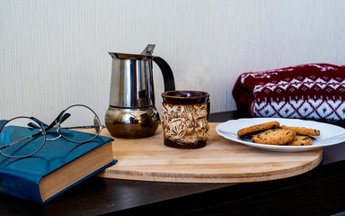 reading a book with coffee and cookies