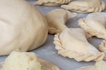 Uncooked vareniki (dumplings) with mashed potato, traditional Ukrainian food