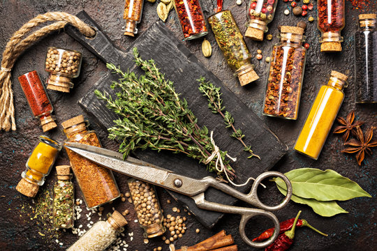 Different spices, dry kitchen herbs and seeds in glass vials for tasty meals - Powered by Adobe