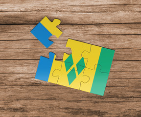 Saint Vincent And The Grenadines national flag on jigsaw puzzle. One piece is missing. Danger...