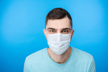 Portrait of young man wearing protective mask against the coronavirus. Infection and quarantine concept