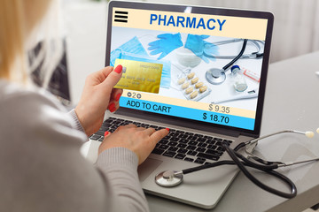 long-haired woman buying drugs online with laptop at home