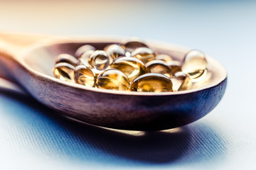 Cod liver oil capsules in a fish shape with copy space. Healthcare concept