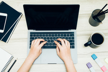 Fototapeta premium newsletter concept Hand of businessman checking message box on digital laptop Vintage tone filter.Top view