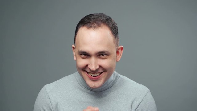 Video of young plotting man in turtleneck