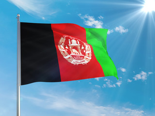 Afghanistan national flag waving in the wind against deep blue sky. High quality fabric. International relations concept.