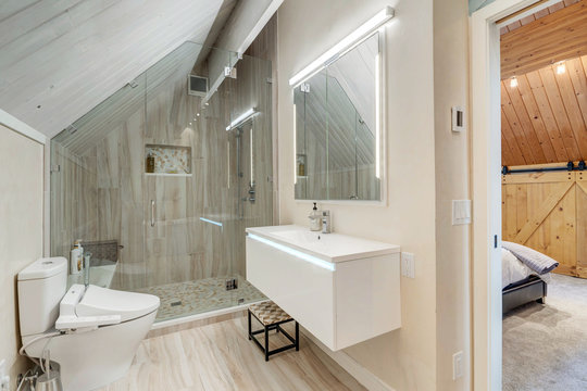 Luxury bathroom interior with free standing modern tub, mural, vaulted wooden ceiling, large and bright.
