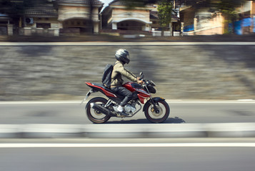 Fototapeta na wymiar Fast moving moped with panning technique