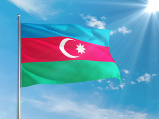 Azerbaijan national flag waving in the wind against deep blue sky. High quality fabric. International relations concept.