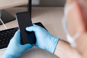 man in a mask and gloves running at home