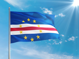 Cape Verde national flag waving in the wind against deep blue sky. High quality fabric. International relations concept.