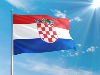 Naklejka premium Croatia national flag waving in the wind against deep blue sky. High quality fabric. International relations concept.